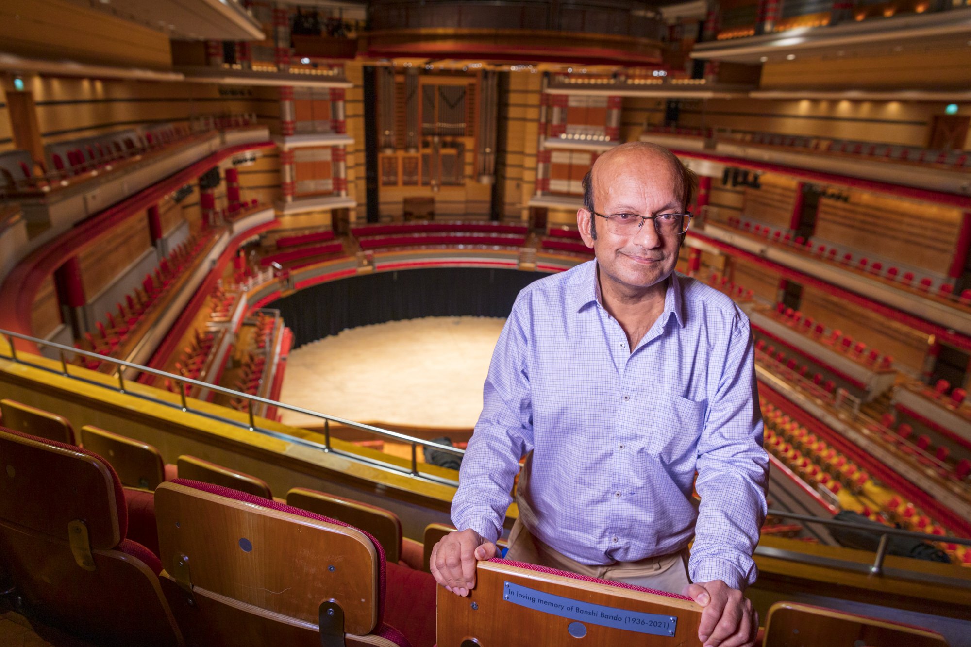 Siddhartha Bandyopadhyay stands in front of his father's seat in the Grand Tier.